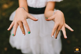 Small hands are showcased in Virginia, USA, as the flower girl’s manicure displayed for a detail shot, highlighting meaningful details that add to the day’s festive spirit.